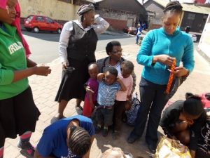 Zimbabwean women learning life skills on the street since they have no office space, Southern African Empowerment Initiatives: Zimbabwean Women in Exile in South Africa