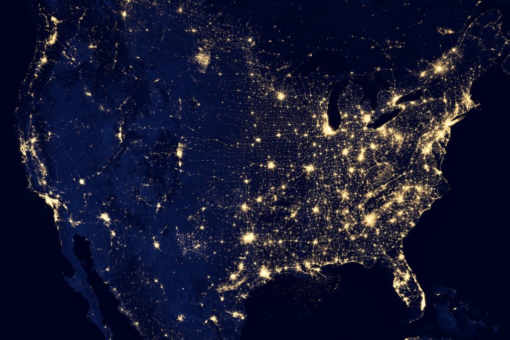 Image of United States with a blacked out background with spots of light connected to each other by trails of light.
