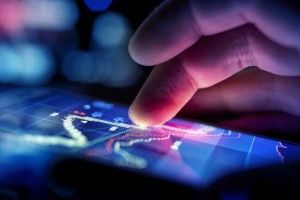 Hand of a business man checking data on a handheld device