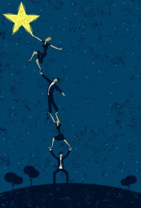 Picture of people stand on each other to reach a star