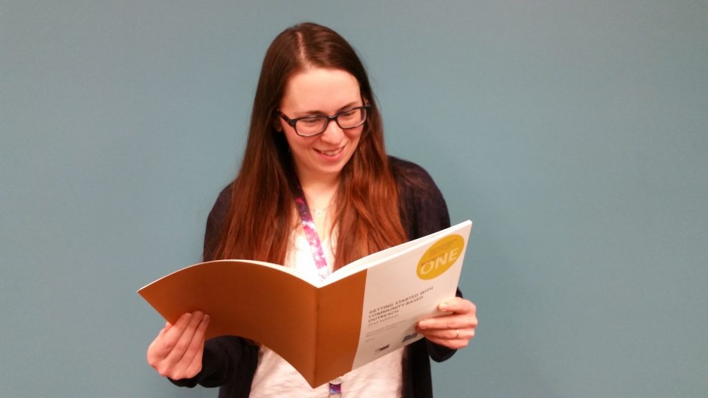 Kalyna Durbak looking at an evaluation booklet