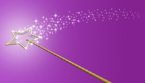 Gold magic wand with sparkles on purple background