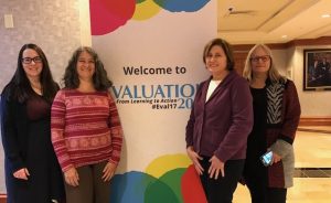 NEO staff in front of AEA banner. From left: Kalyna Durbak, Karen Vargas, Cindy Olney, Susan Wolfe