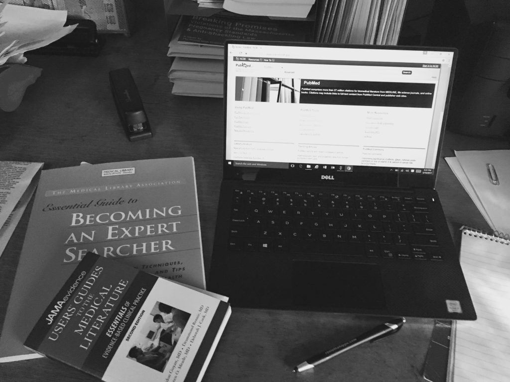 desk with books and an open laptop