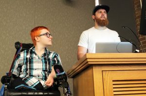 K Wheeler and Shawn Berg demonstrate screen reader software from a podium at the front of a UW classroom
