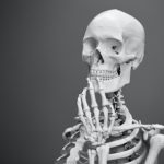 skeleton holding fingers to chin pensively