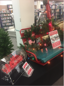 library raffle with red chair life and tickets in a raffle container