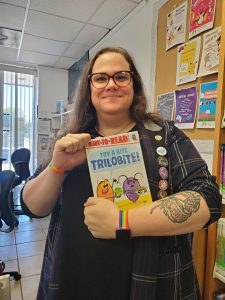 Katherine Smith smiling and holding a book