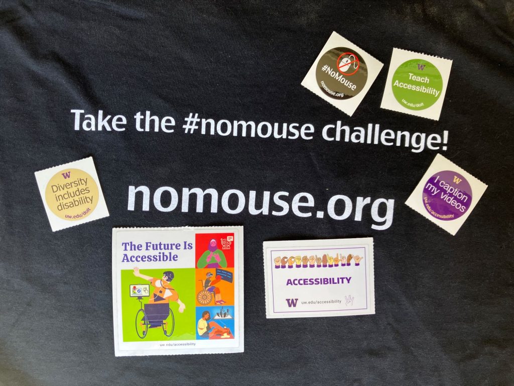 Souvenirs from the GAAD 2024 event: a t-shirt that says "take the #nomouse challenge - nomouse.org" and stickers celebrating accessibility and diversity, with messages such as "The Future is Accessible" and "I caption my videos"