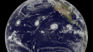 Image of earth from space. Three cyclones are shown in the Pacific Ocean.