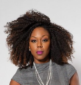 Headshot of Porcha Johnson, founder and Executive Director of Black Girl Health. Picture of a black woman with natural hair from the shoulders up in a gray dress.