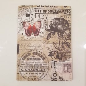 Papercraft. Collage of maps, newspaper, script, pen drawing of flower, music notes and more. 