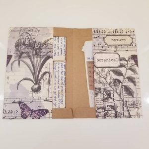 Papercraft envelope/folder. Collage with themes of music notes, plants, butterfly, and bullet journal tucked inside. 