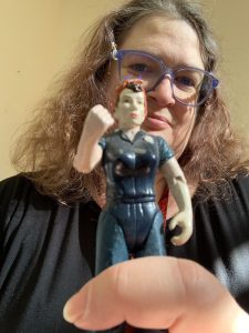 Woman holding superhero figure