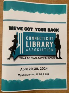 Photo of conference brochure for the Connecticut Library Association held at the Mystic Marriott and Spa April 29 and 30. Conference logo says "We've got your back".