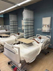 Hospital room with a mannequin in the bed.