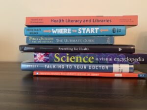 Stack of books to create book spine poetry. Health Literacy and Libraries. Where to start? The ultimate guide: searching for health science, talking to your doctor, promoting individual and community health at the library.